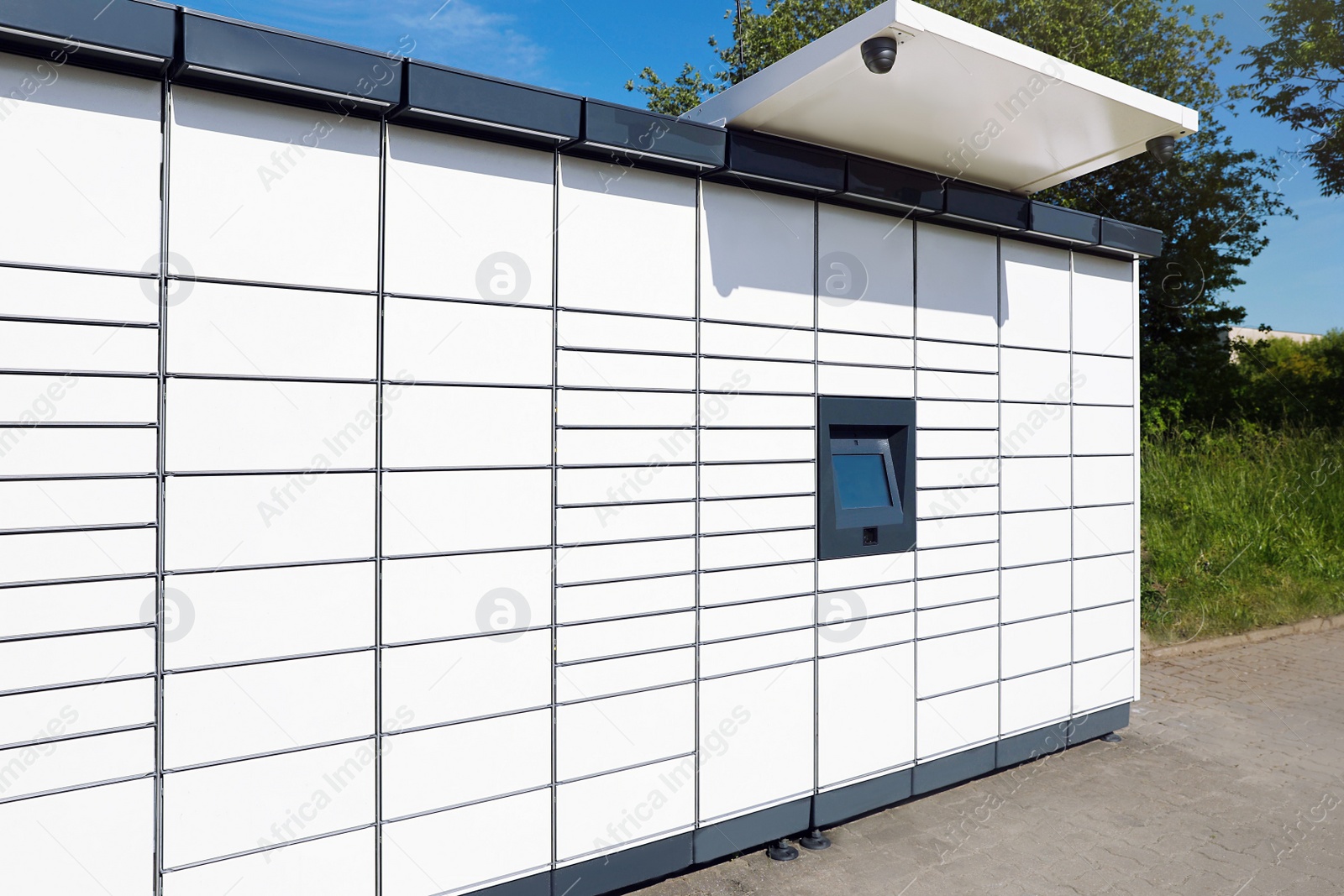 Photo of Modern parcel locker with many postal boxes outdoors