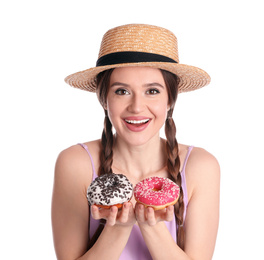 Beautiful young woman wearing stylish hat with donuts on white background