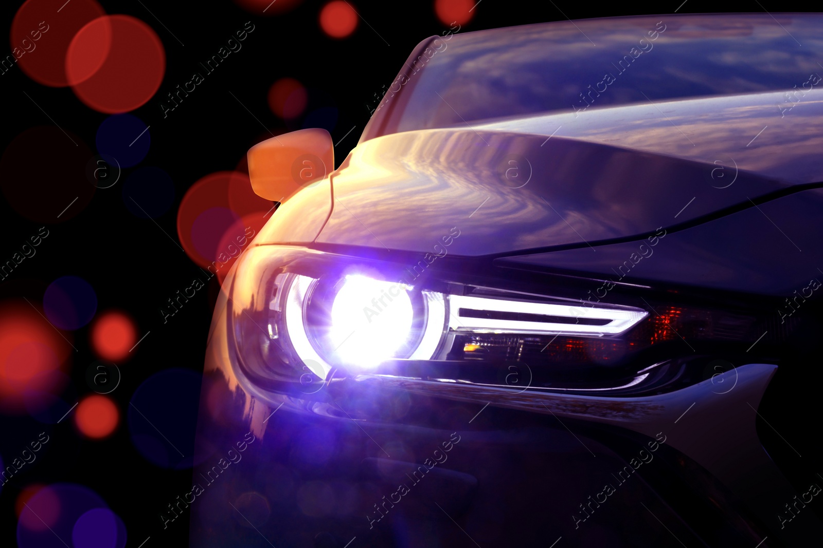 Image of Black modern car on black background, closeup. Bokeh effect