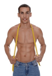 Photo of Handsome shirtless man with slim body and measuring tape isolated on white