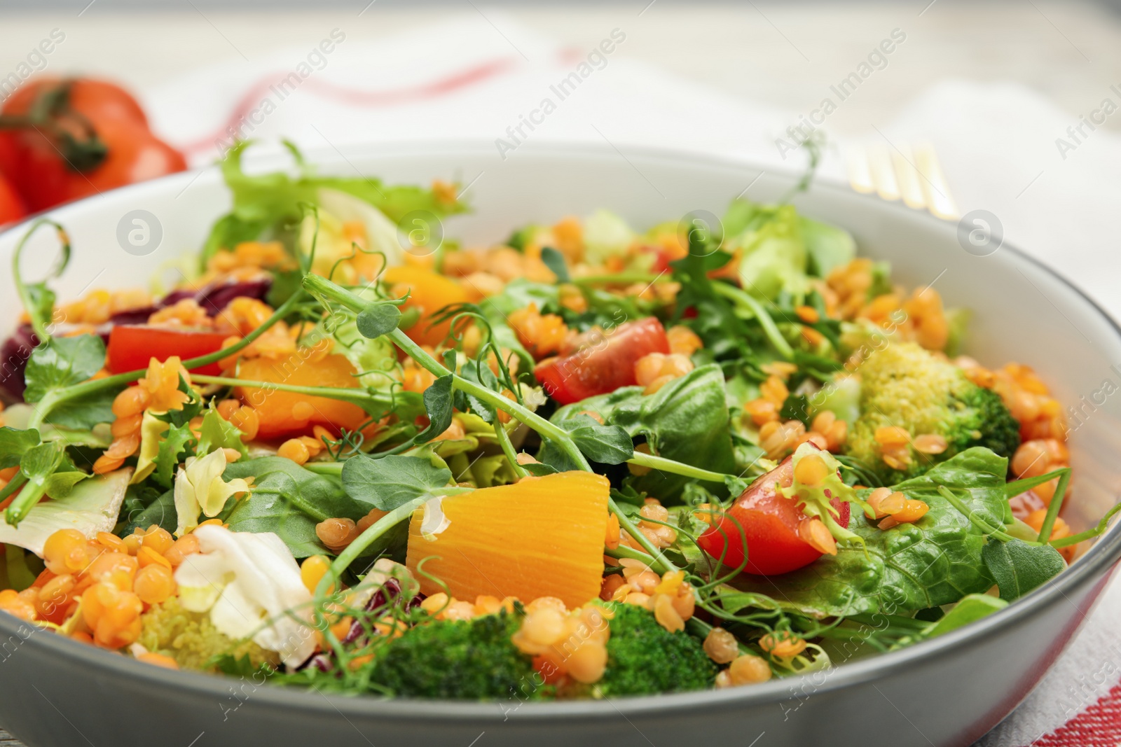 Photo of Delicious salad with lentils and vegetables in bowl, closeup