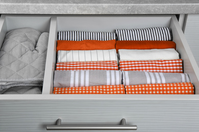 Towels with pattern and orange in drawer