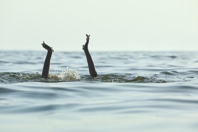 Photo of Drowning woman reaching for help in sea