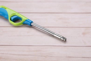 One gas lighter on white wooden table