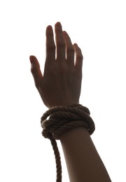 Photo of Freedom concept. Woman with rope on her hand against white background, closeup