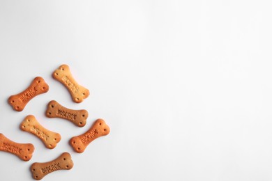 Bone shaped dog cookies on white background, top view. Space for text