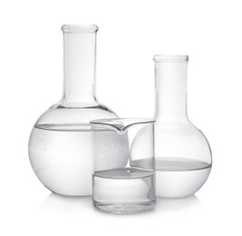 Photo of Laboratory glassware with transparent liquid on white background