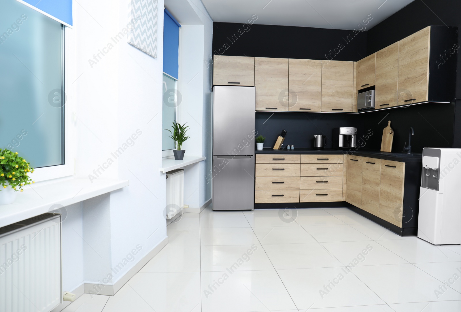 Photo of Cozy modern kitchen interior with new furniture and appliances