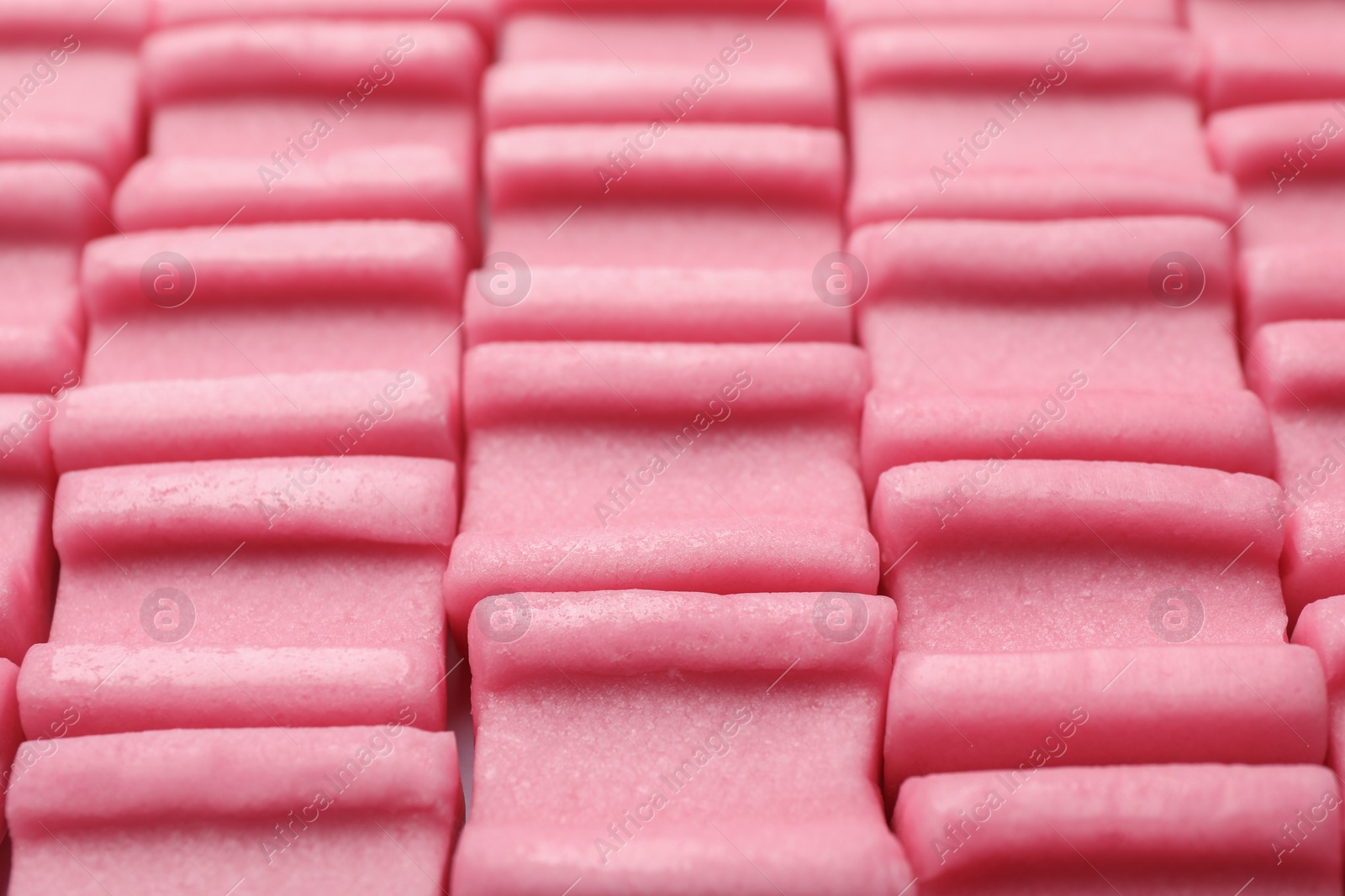 Photo of Tasty pink chewing gums as background, closeup