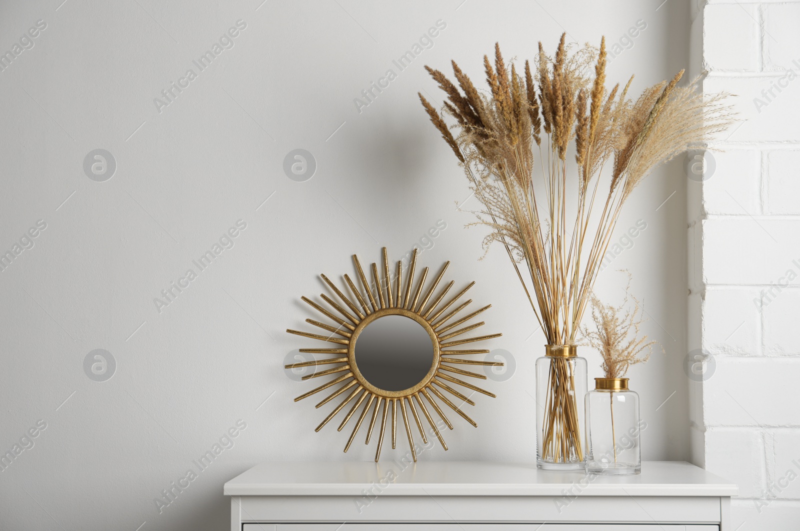 Photo of Stylish decorative vases on commode in room