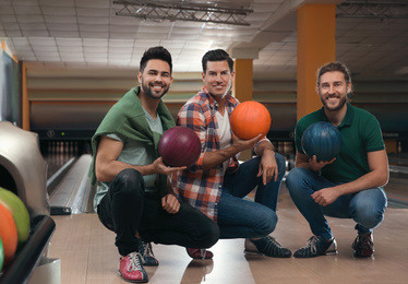 Photo of Group of men with balls in bowling club