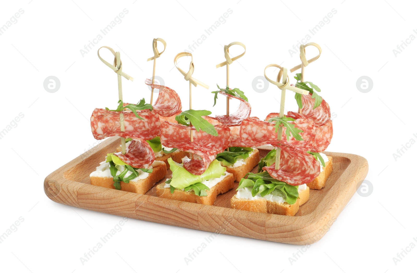 Photo of Tasty canapes with salami, greens and cream cheese isolated on white