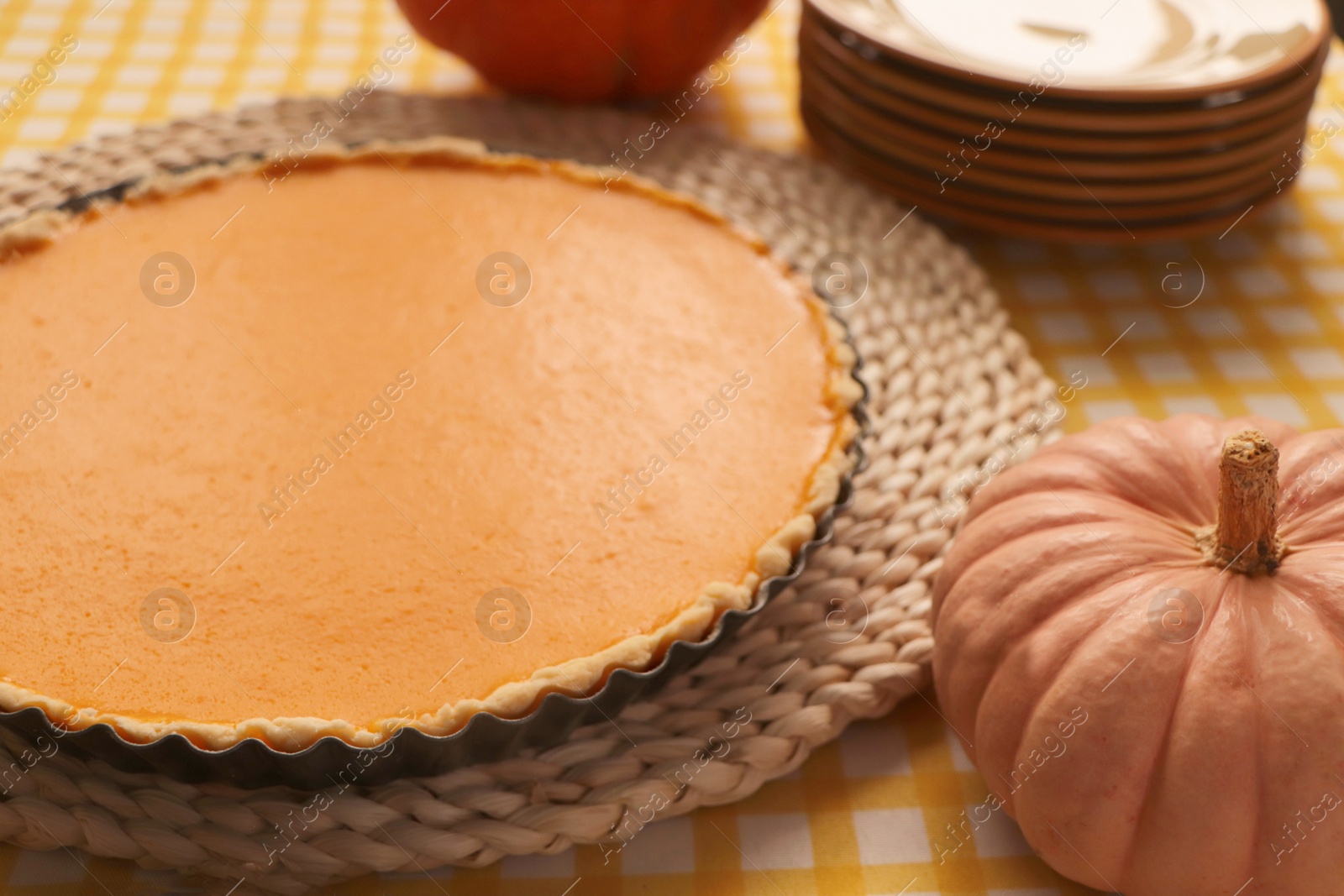 Photo of Delicious homemade pumpkin pie in baking dish on table