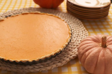 Delicious homemade pumpkin pie in baking dish on table