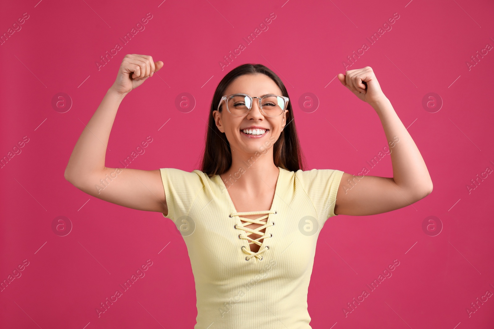 Photo of Strong woman as symbol of girl power on pink background. 8 March concept