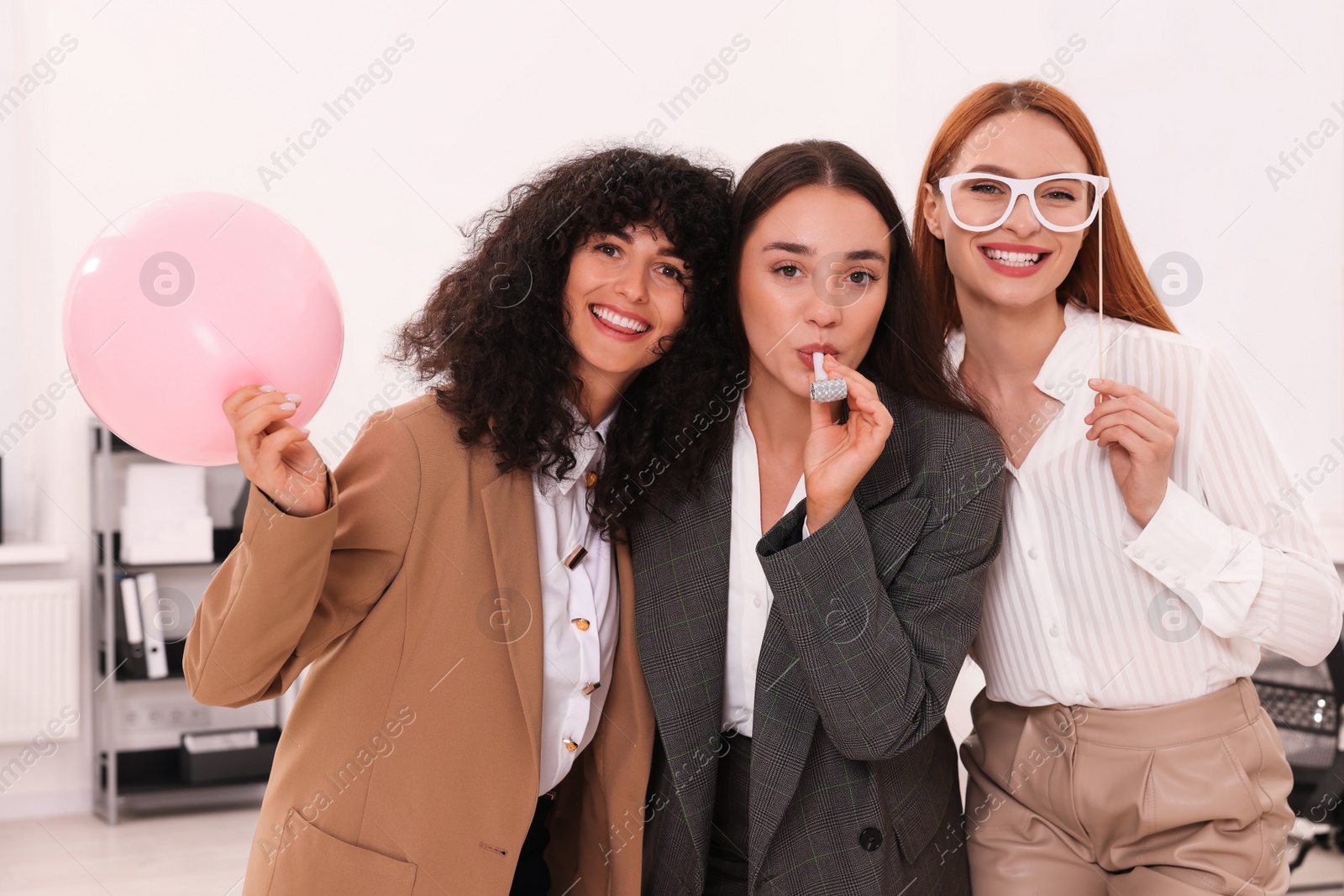 Photo of Coworkers having fun during office party indoors