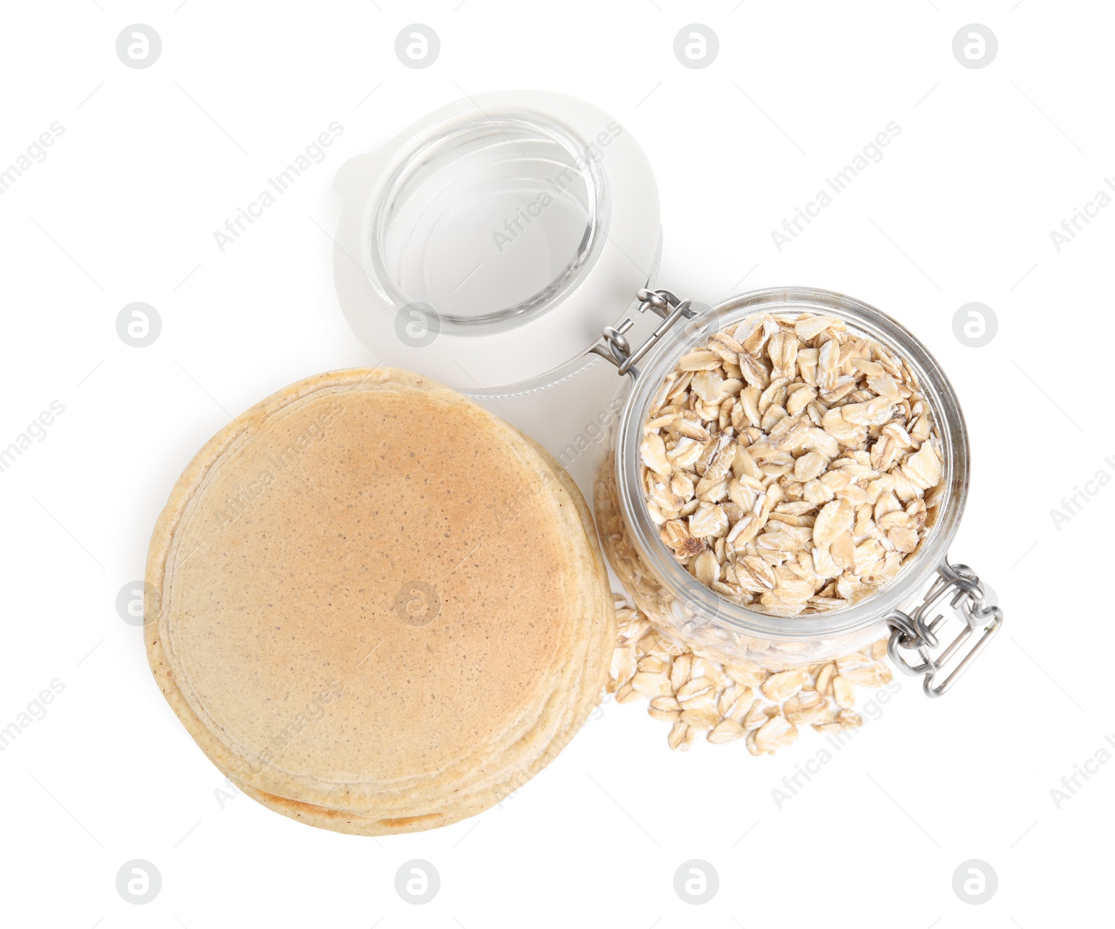 Photo of Tasty oatmeal pancakes and flakes on white background, top view