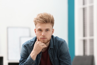 Portrait of handsome young man in room