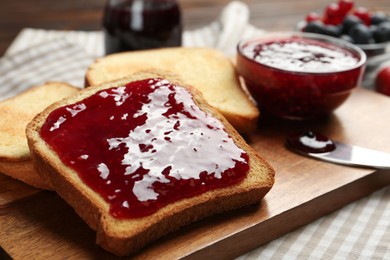 Photo of Delicious toasts with jam served on table, closeup