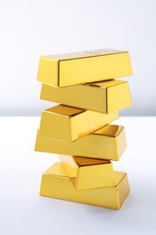 Photo of Many shiny gold bars isolated on white
