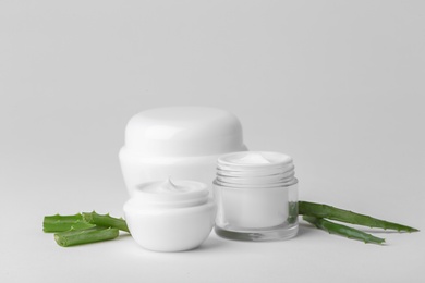 Photo of Jars of body cream on light background