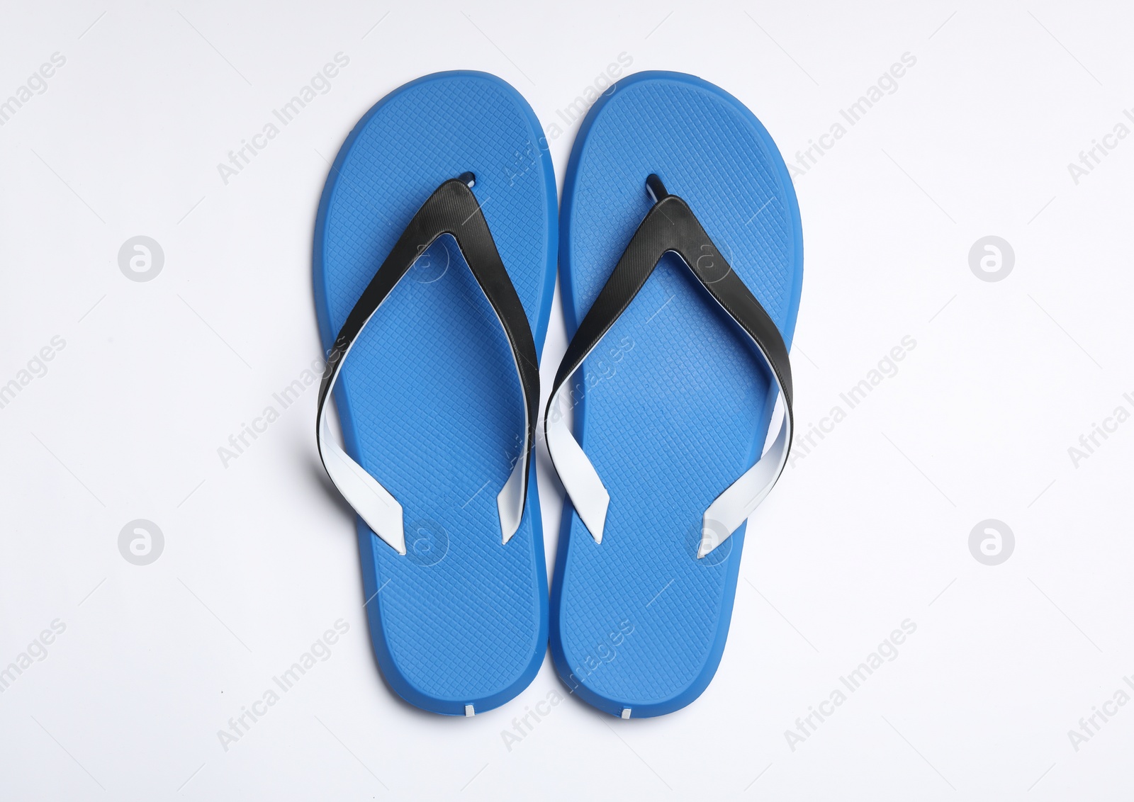 Photo of Pair of flip flops on white background, top view. Beach accessories