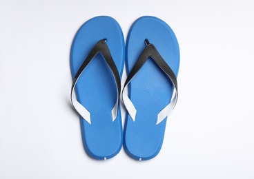 Photo of Pair of flip flops on white background, top view. Beach accessories