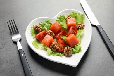 Photo of Plate with salad on grey background. Heart-healthy diet