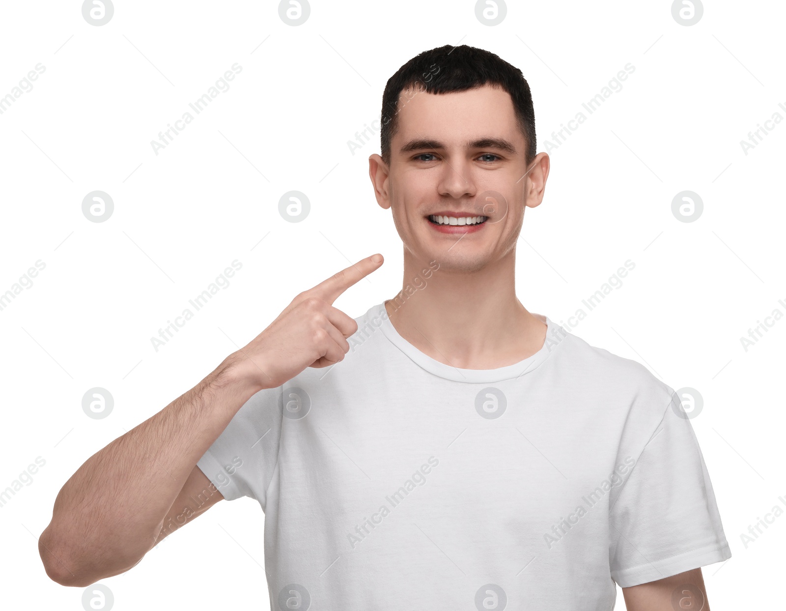 Photo of Handsome young man showing his clean teeth on white background