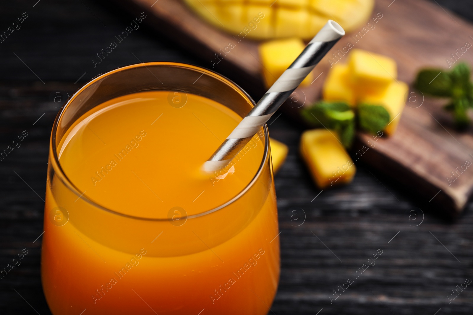 Photo of Fresh delicious mango drink on table, closeup