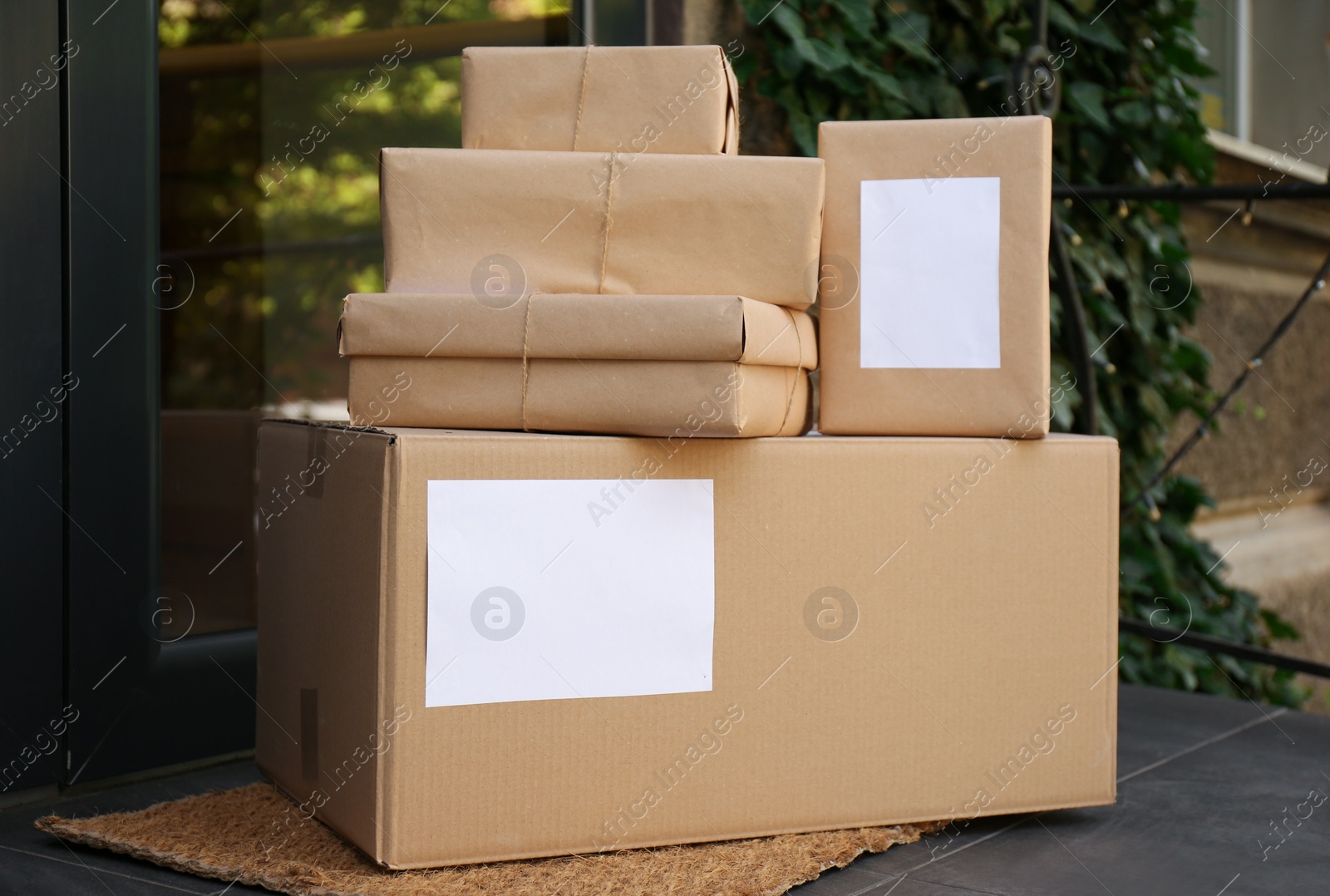 Photo of Delivered parcels on door mat near entrance