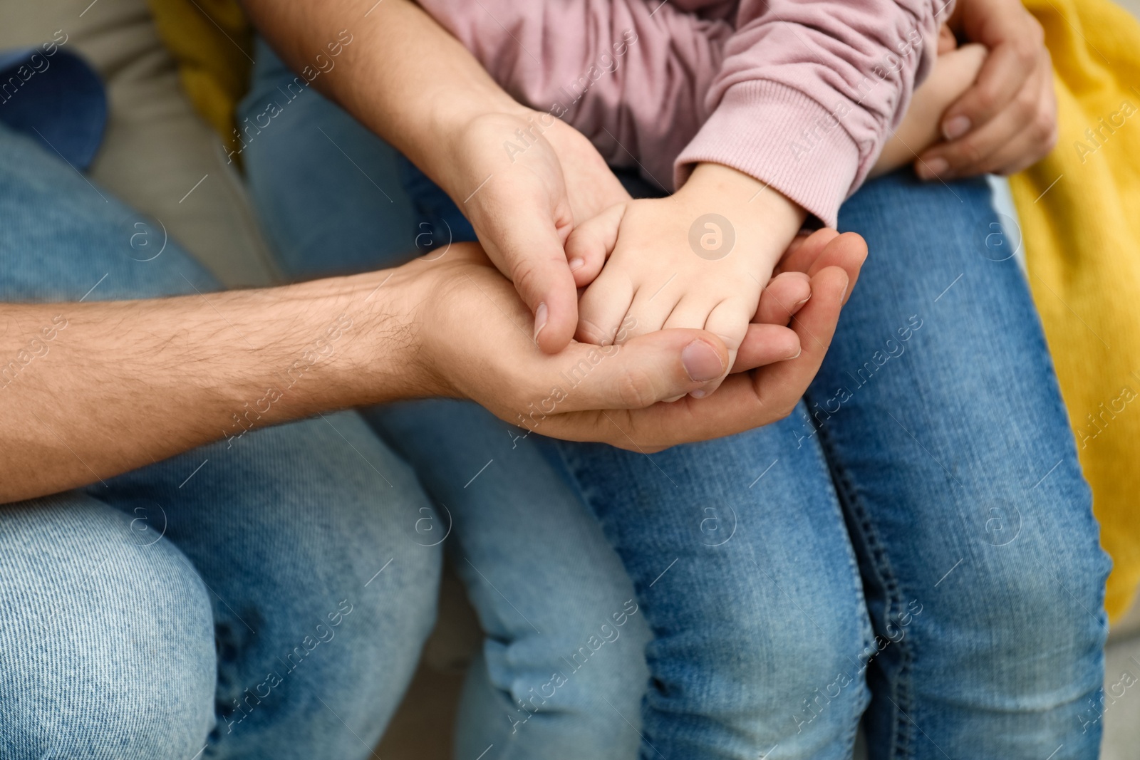 Photo of Closeup view of happy family holding hands