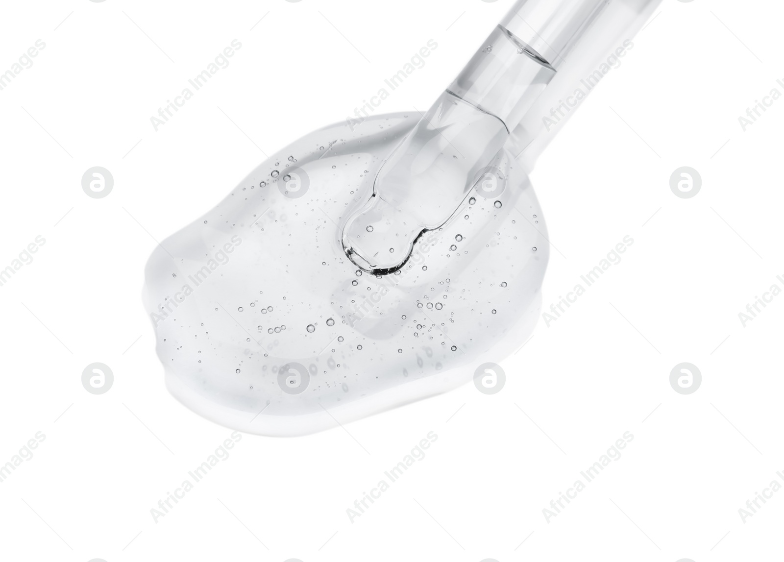 Photo of Dripping cosmetic oil from pipette onto light surface, closeup