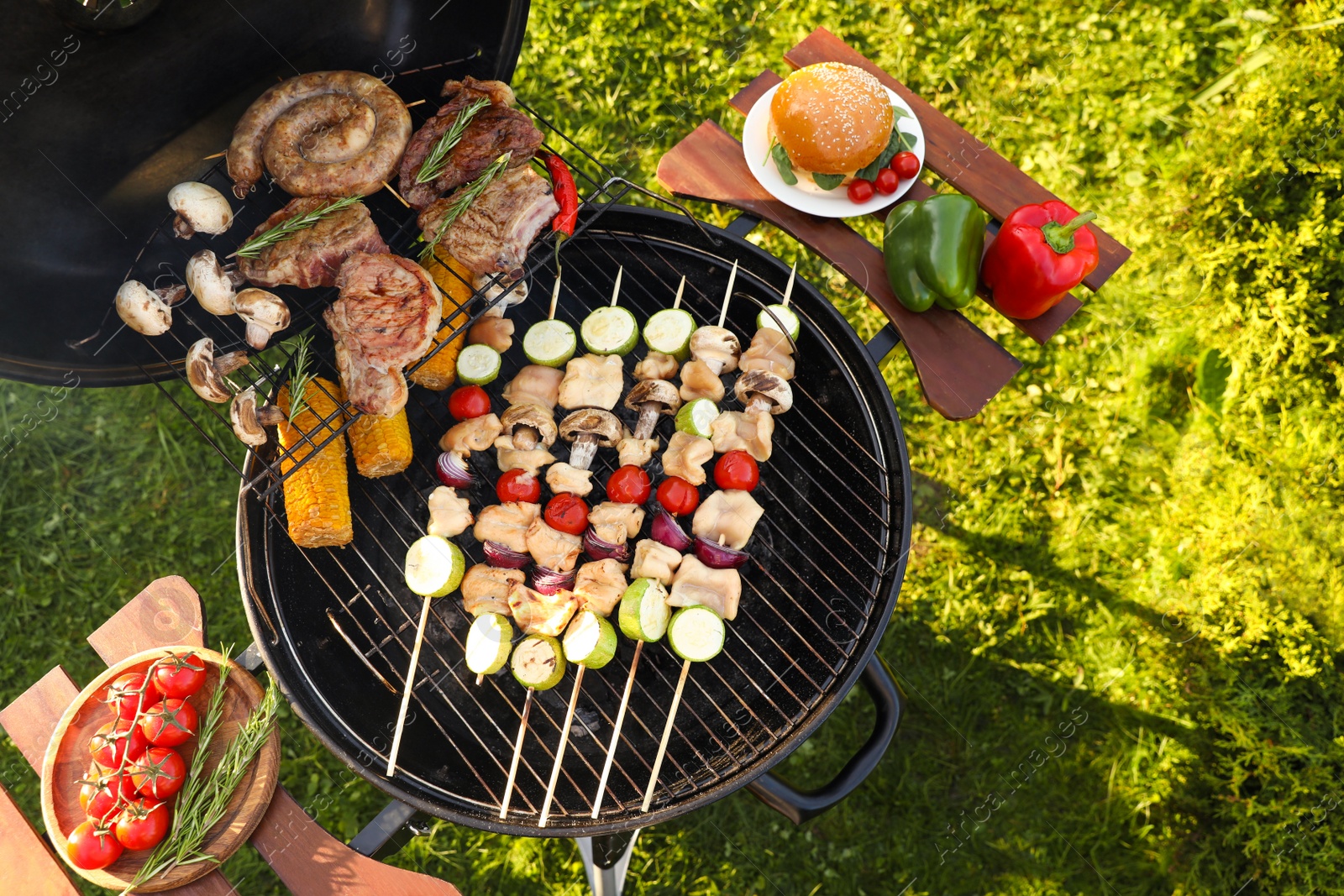 Photo of Cooking meat and vegetables on barbecue grill outdoors, flat lay