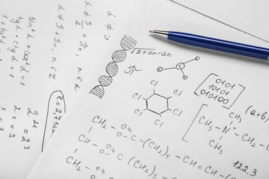 Photo of Sheets of paper with different chemical formulas and pen, closeup