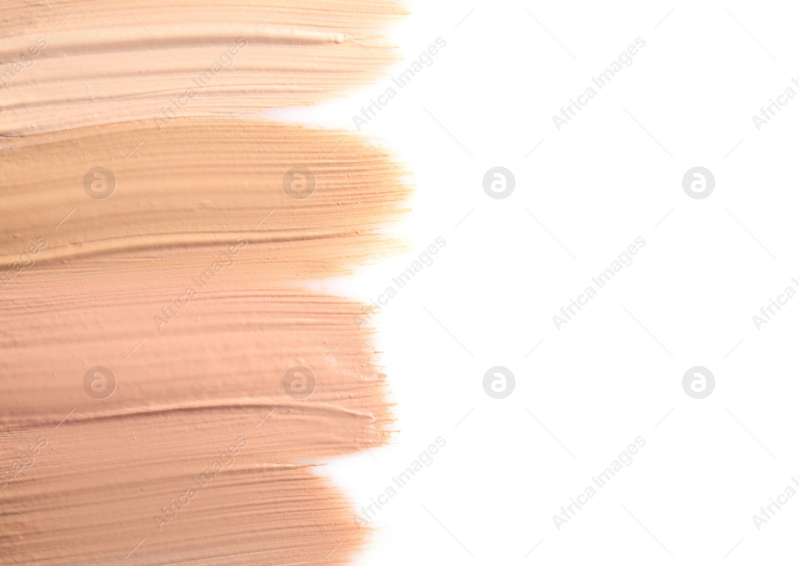 Photo of Samples of different foundation shades on white background, top view