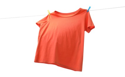 One orange t-shirt drying on washing line isolated on white