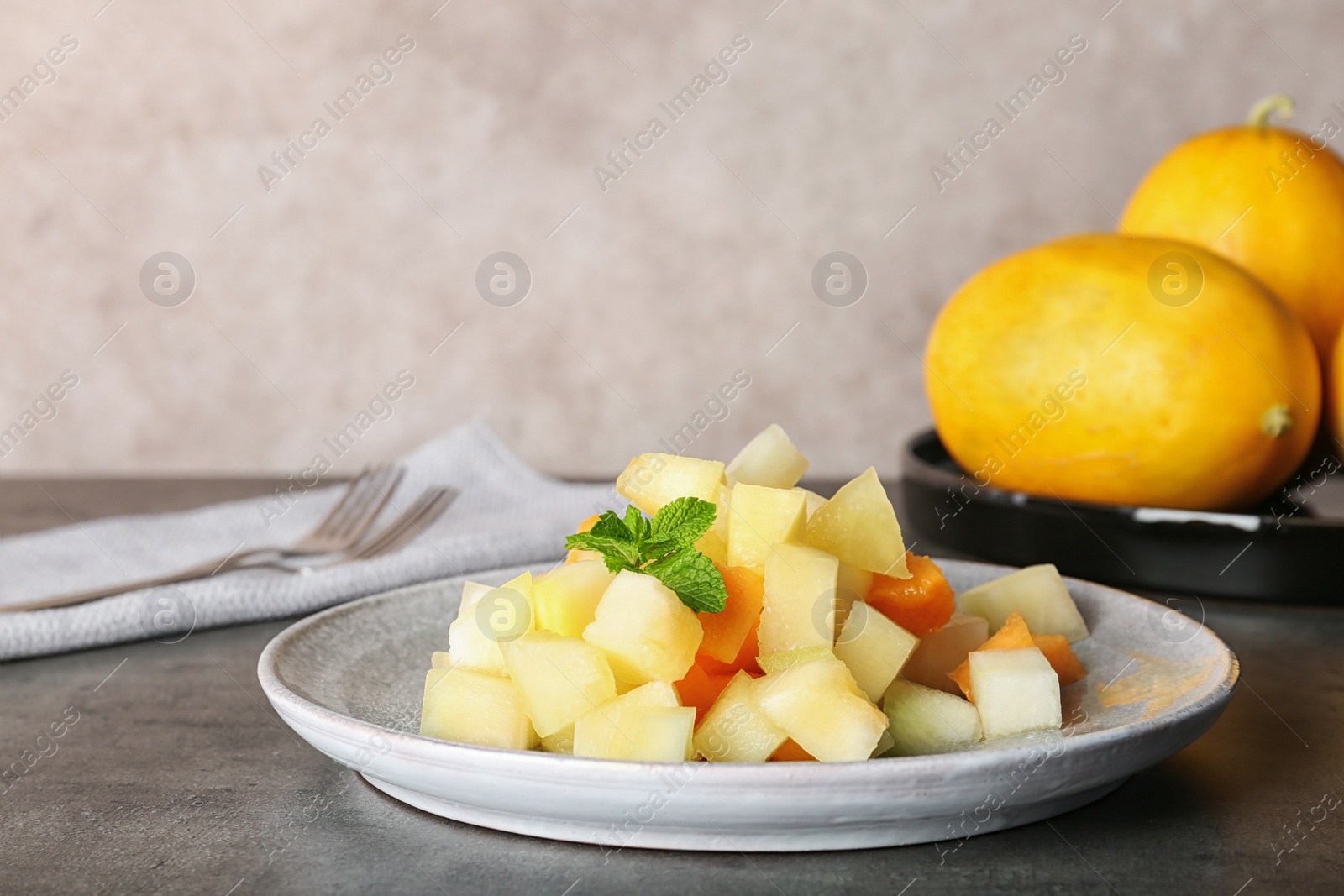 Photo of Plate of salad with assorted melons on table