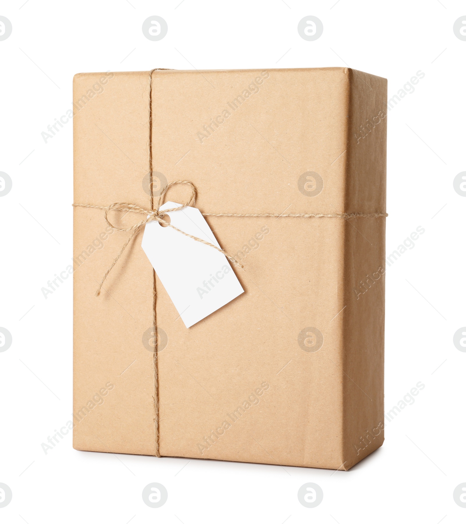 Photo of Gift box wrapped in kraft paper with bow and tag isolated on white