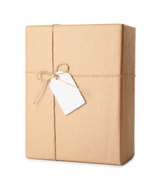 Photo of Gift box wrapped in kraft paper with bow and tag isolated on white
