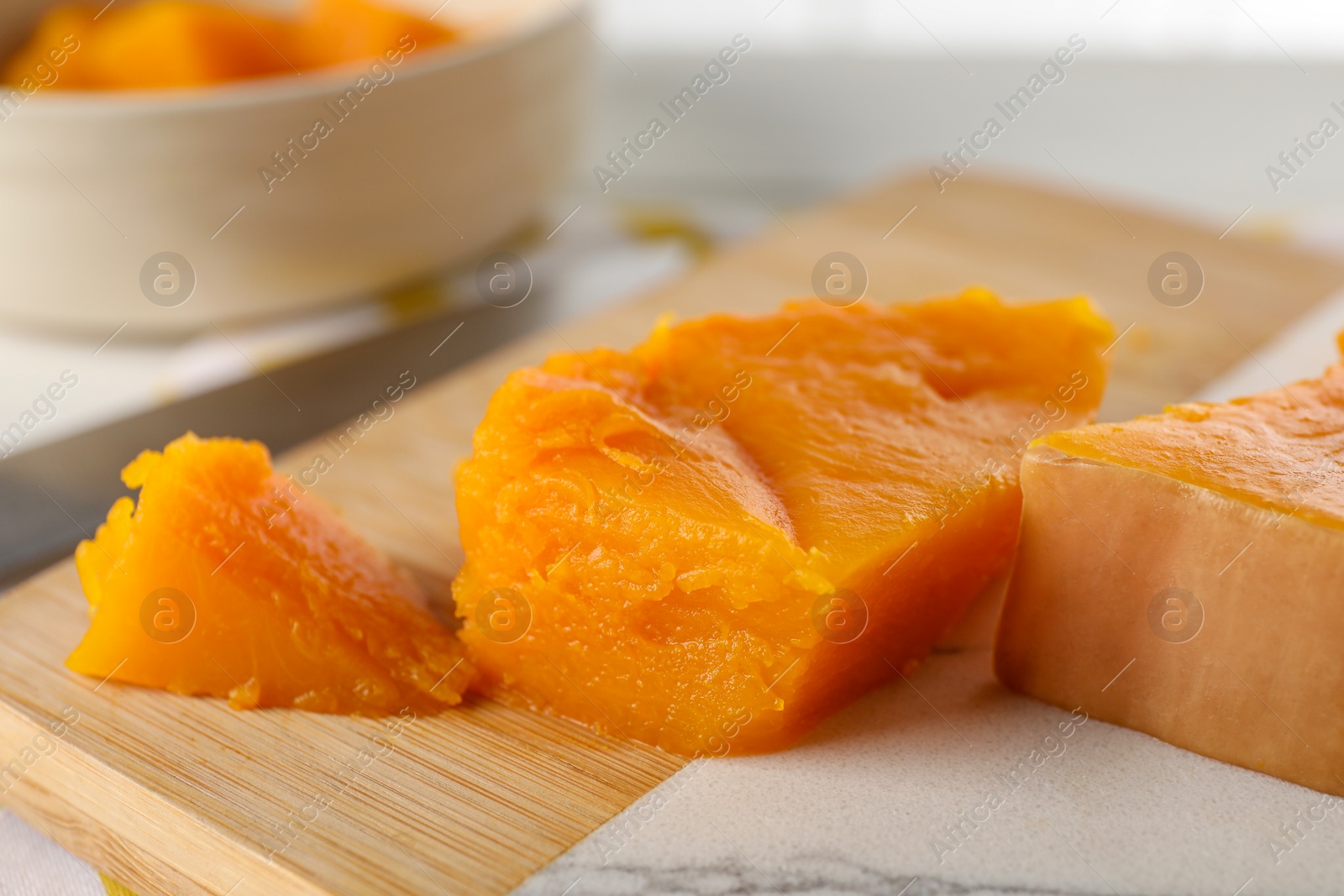 Photo of Pieces of boiled pumpkin on white table, closeup. Child's food