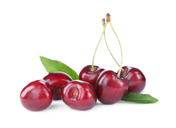 Photo of Tasty ripe red cherries with green leaves isolated on white