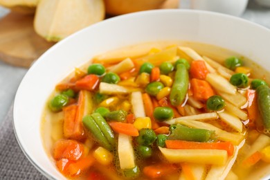 Photo of Bowl of delicious turnip soup, closeup view