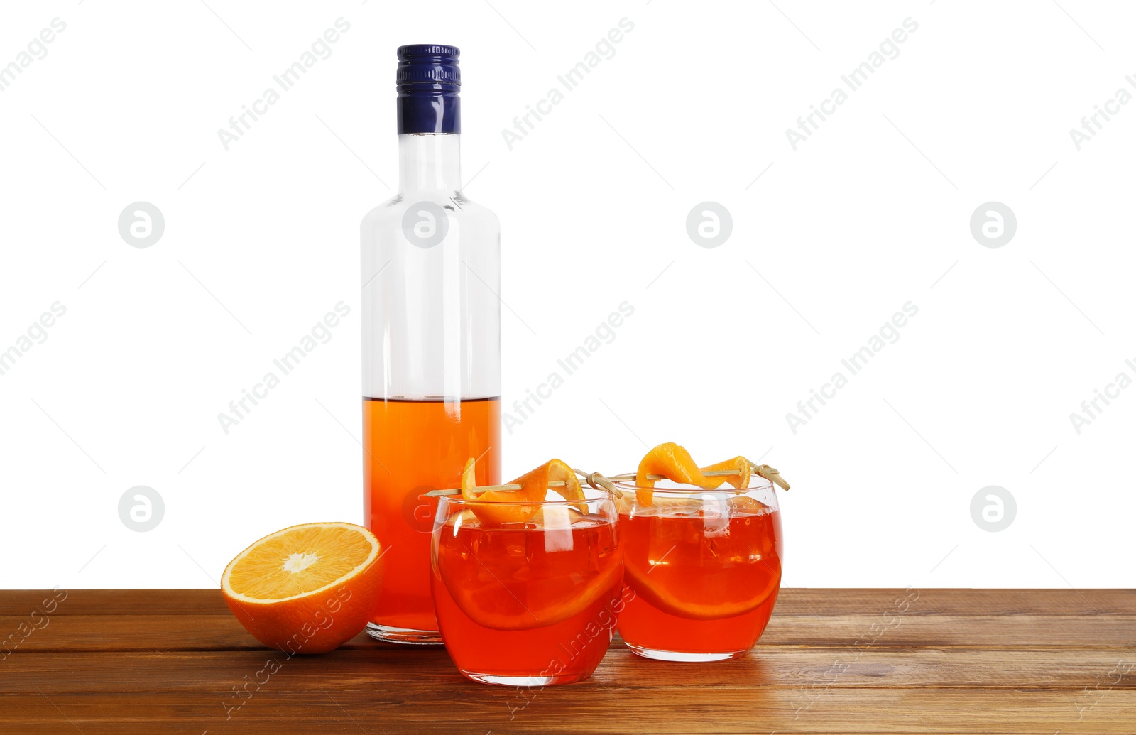 Photo of Aperol spritz cocktail and orange slices in glasses on wooden table against white background