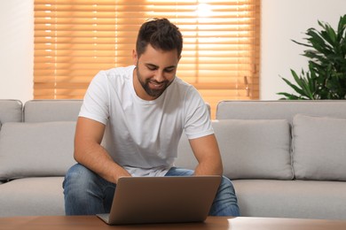 Man using laptop for online shopping at home