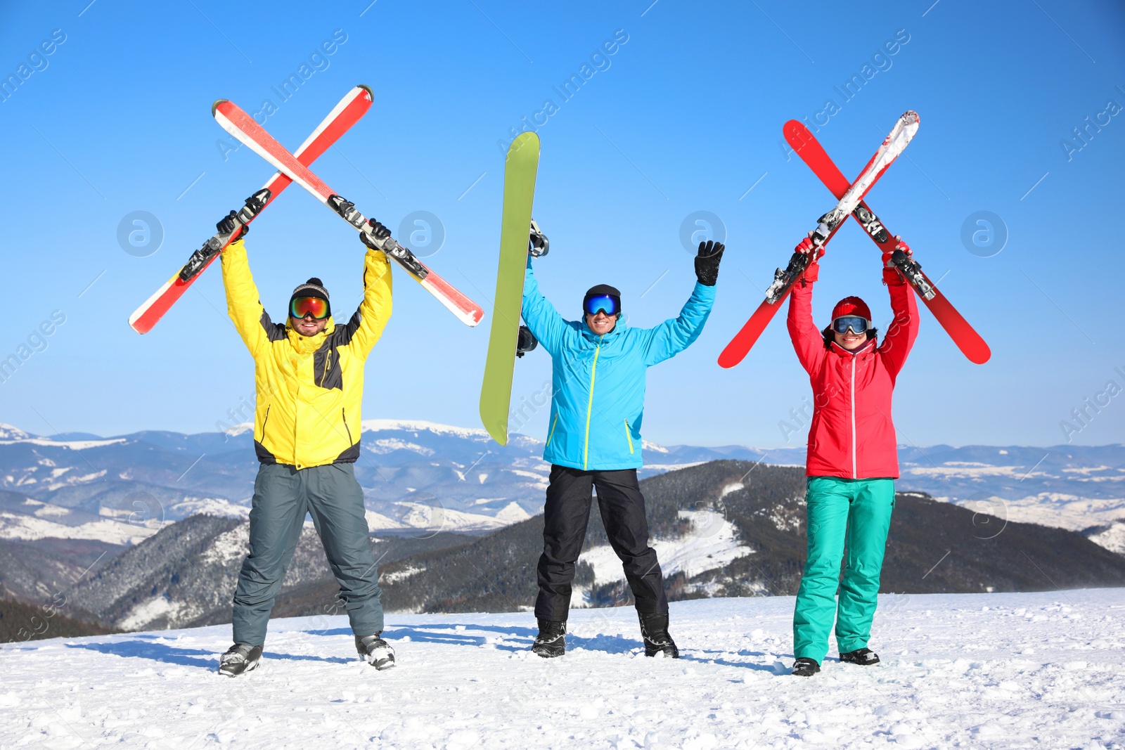 Photo of Friends with equipment at ski resort. Winter vacation