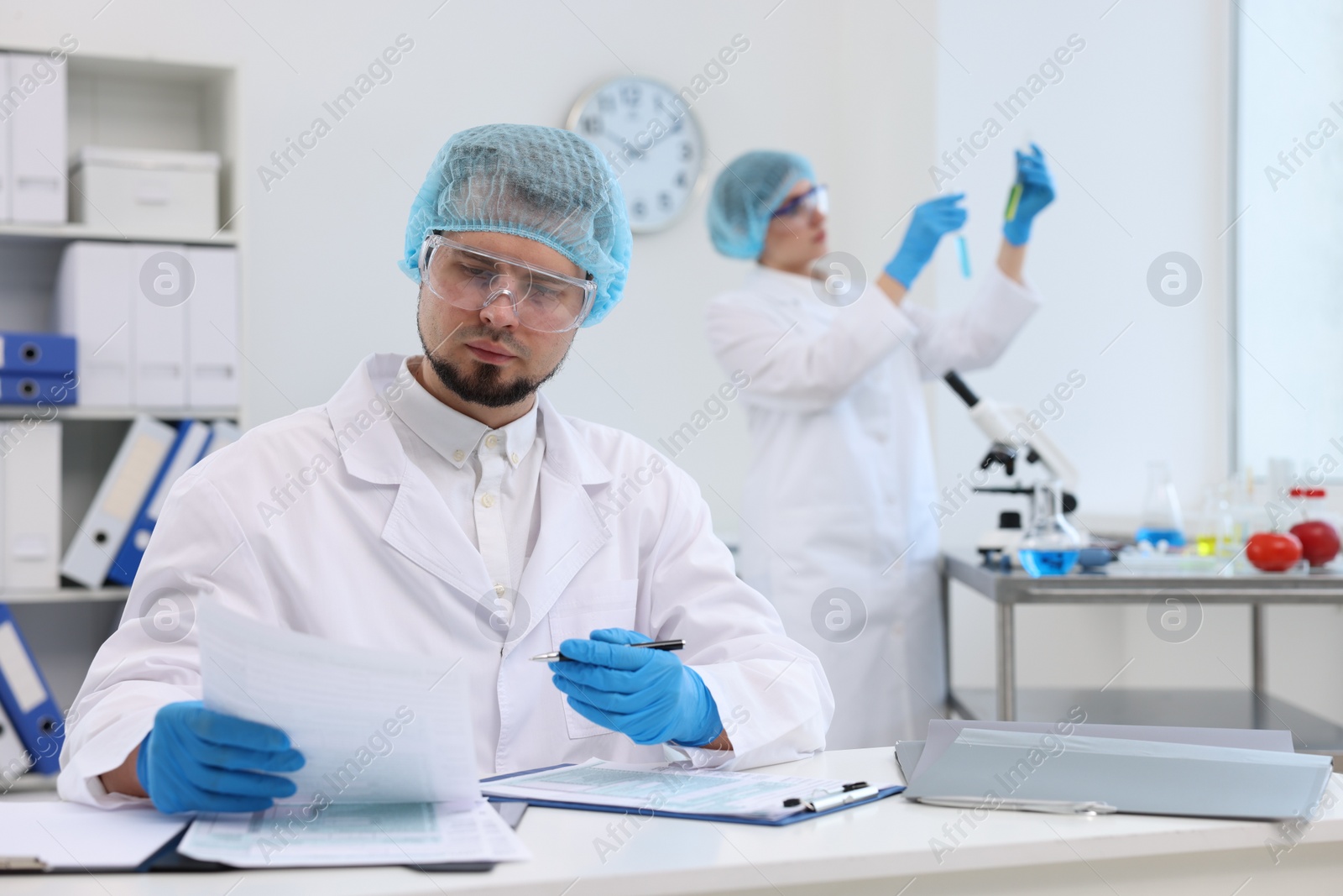 Photo of Quality control. Food inspectors checking safety of products in laboratory