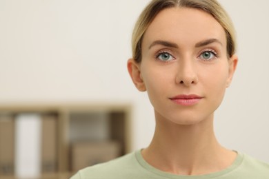 Portrait of beautiful woman indoors, space for text