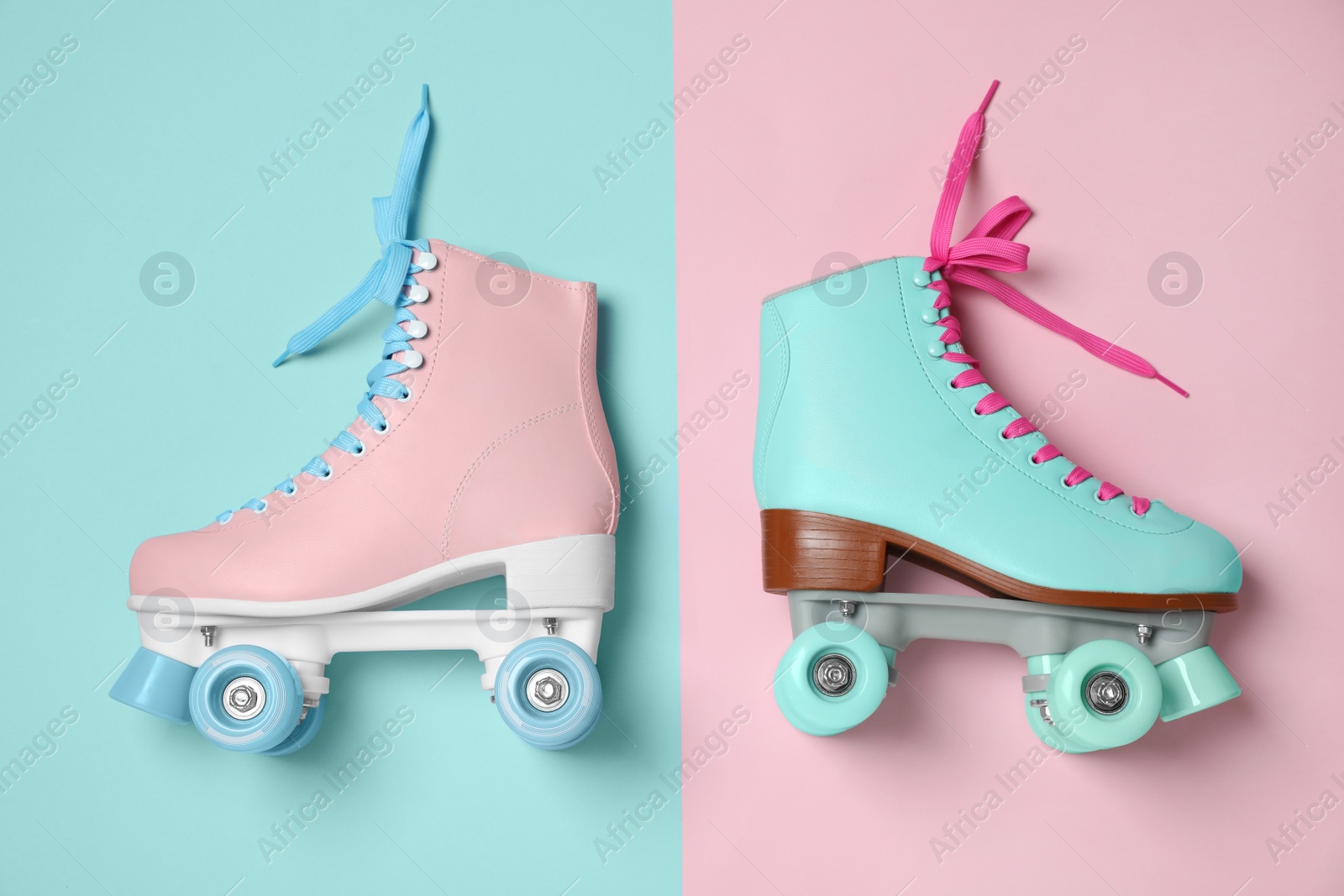 Photo of Vintage roller skates on color background, top view