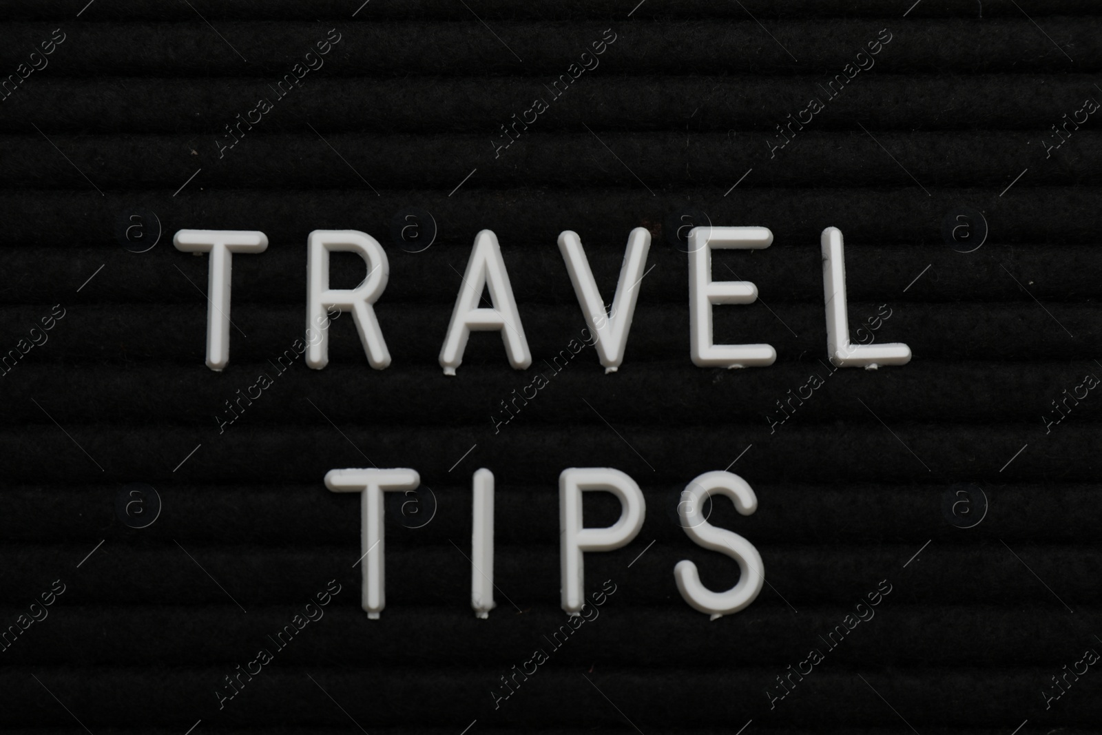 Photo of Phrase Travel Tips on black letter board as background, top view